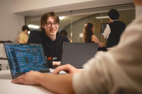 un étudiant assis devant son ordinateur